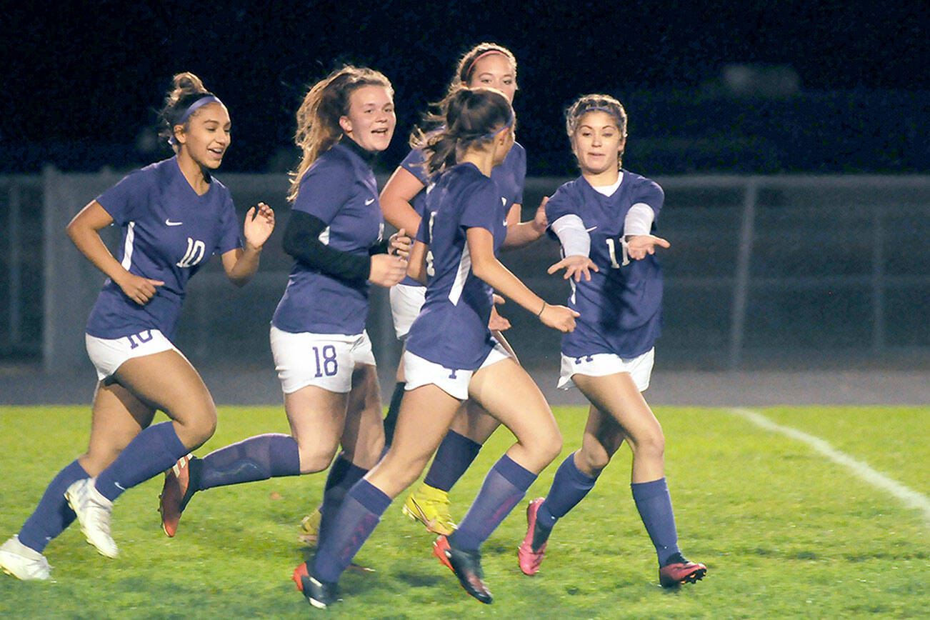 Michael Dashiell/Olympic Peninsula News Group
Sequim teammates, from left, Jenny Gomez, Jenna Mason, Hailey Wagner (obscured) and Aliyah Weber celebrate Raimey Brewer, front, after her early goal put the Wolves up 1-0 on Kingston on Thursday.