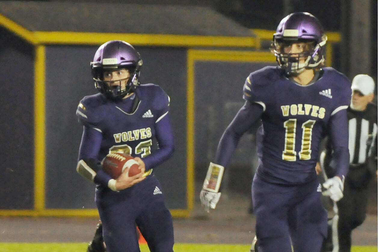 Sequim's Sam Fitzgerald, left, looks for running room as Aiden Gockerell looks to provide a block in the Wolves' season-finale against Bremerton on oct. 28. Fitzgerald had three first half touchdowns. (Michael Dashiell/Olympic Peninsula News Group)