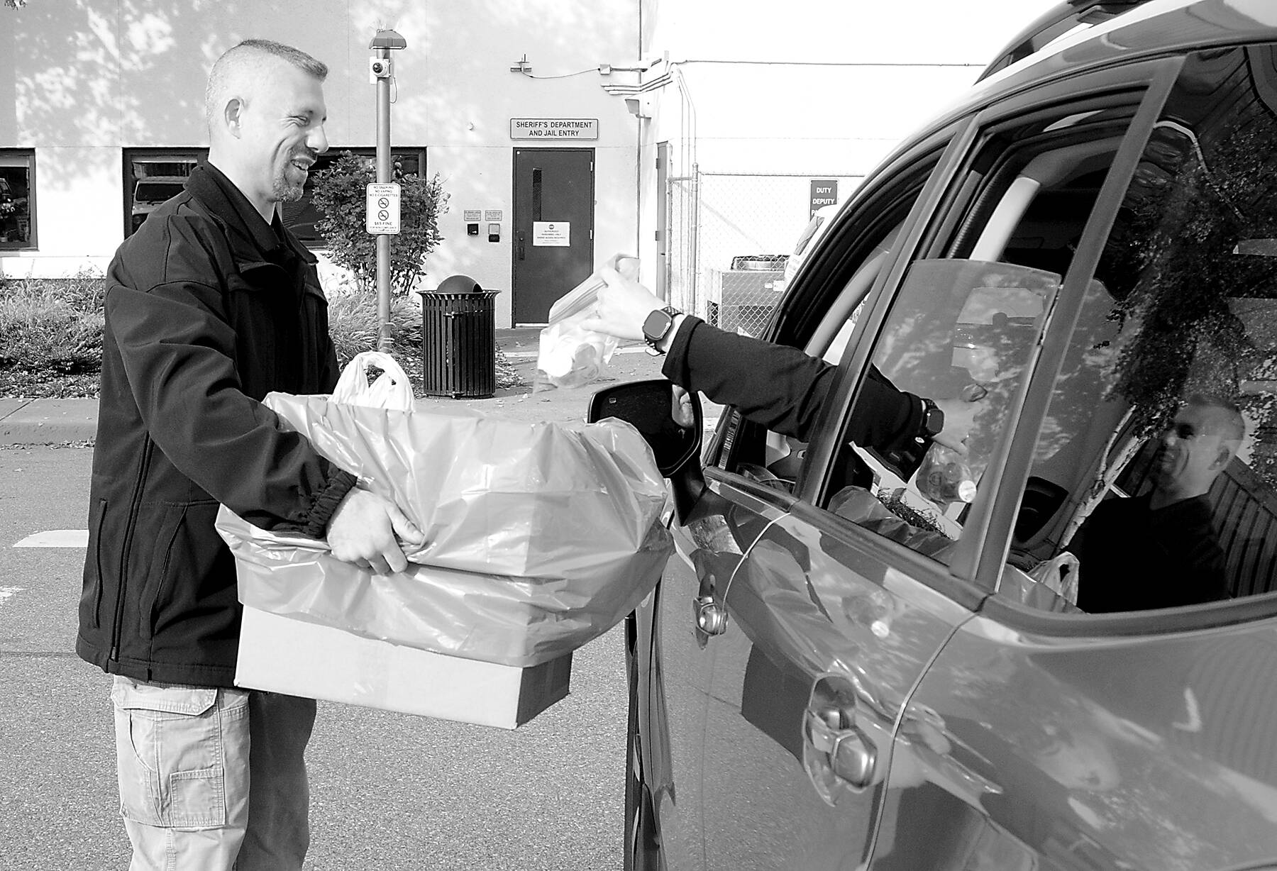 Inspector Josh Ley of the Clallam County Sheriff’s Office accepts a package of medications from a motorist at the Clallam County Courthouse in Port Angeles during National Prescription Drug Take Back Day on Saturday. The nationwide event was developed to provide a safe method of disposing of unwanted, uneeded or expired prescription medications and illicit drugs. (Keith Thorpe/Peninsula Daily News)