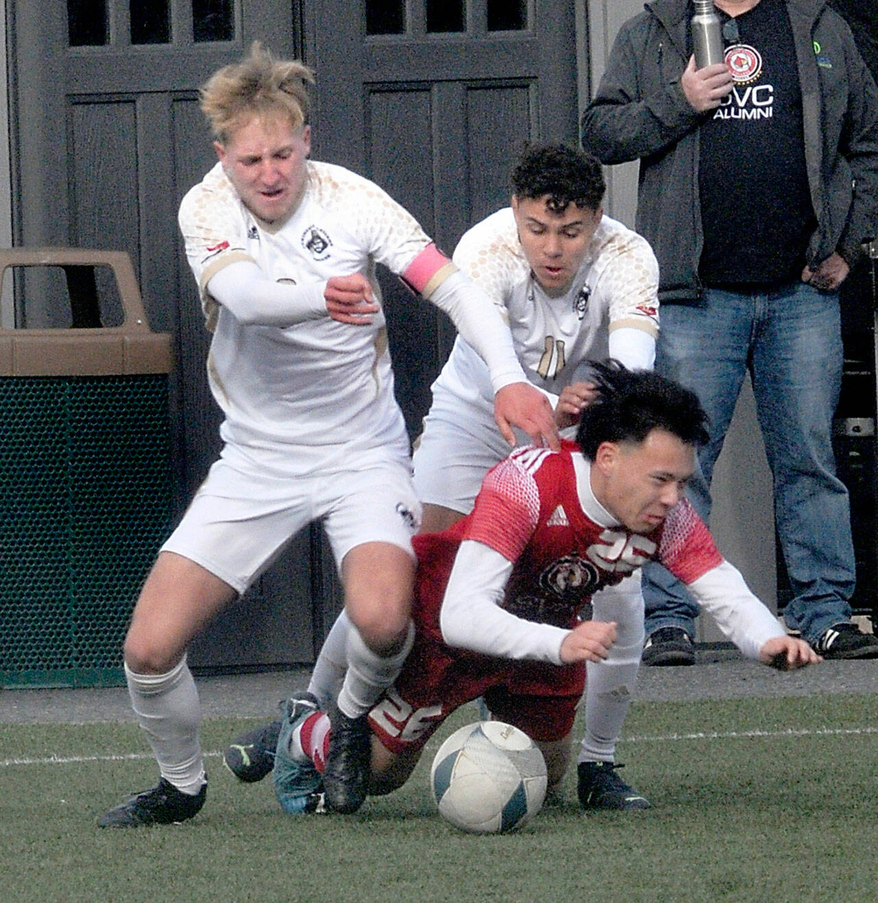 Peninsulas Tim Deser, left, and teammate Alfonso Santos de Cruz battle with Skagit Valleys Oscar Ibarra for a loose ball Saturday in Port Angeles. The Pirates won the physical game 2-1. (Keith Thorpe/Peninsula Daily News)