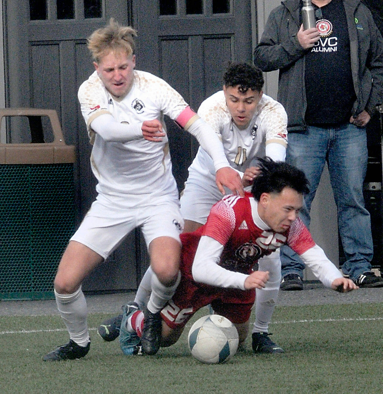 Peninsula’s Tim Deser, left, and teammate Alfonso Santos de Cruz battle with Skagit Valley’s Oscar Ibarra for a loose ball Saturday in Port Angeles. The Pirates won the physical game 2-1. (Keith Thorpe/Peninsula Daily News)