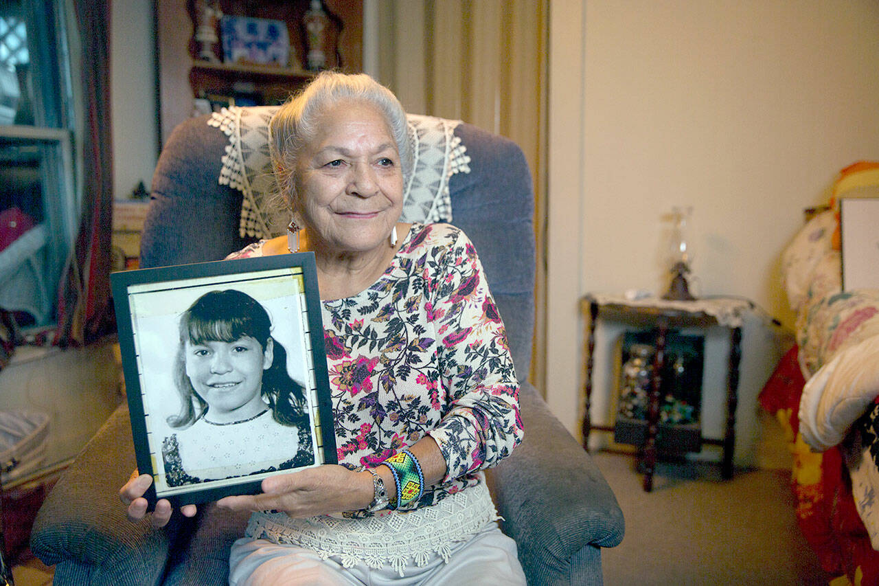 Georgina Sappier-Richardson (Passamaquoddy) holds her childhood photo. (Jeremy Dennis)