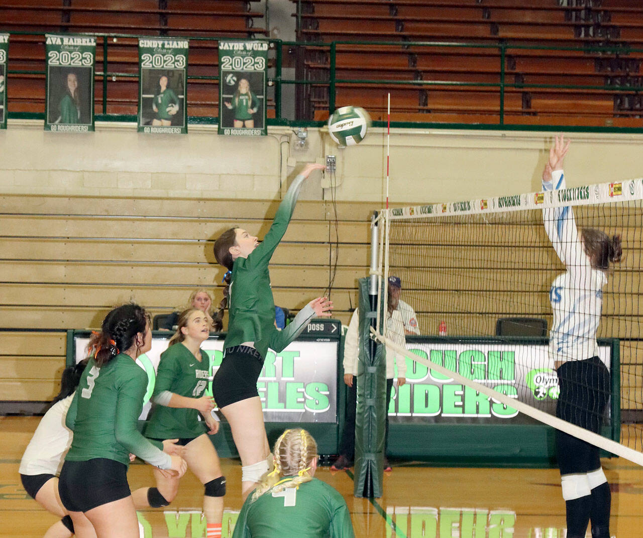 Ava Hairell tips the volleyball back over the net in their match Monday against North Mason. In on the play is Alaina Baublitz (4), Josephine Edgington (3) and Lily Halberg (12). (Dave Logan/for Peninsula Daily News)