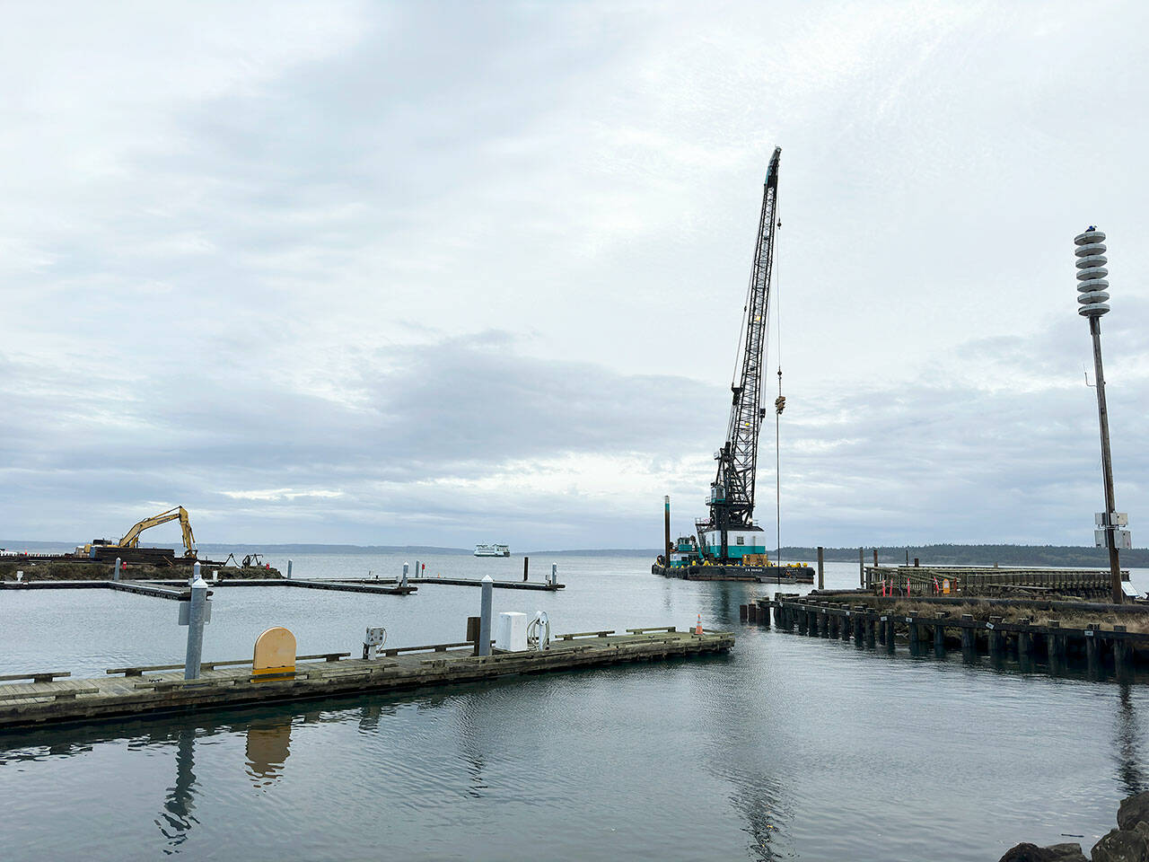 The north end of the Point Hudson Marina is gone, leaving a gaping opening to the marina until it is replaced with a newer breakwater, expected to be in March. The south side will be replaced after the Wooden Boat Festival next September. The M/V Salish is in the background and completing a Monday morning run from Coupeville to Port Townsend. (Steve Mullensky/for Peninsula Daily News)