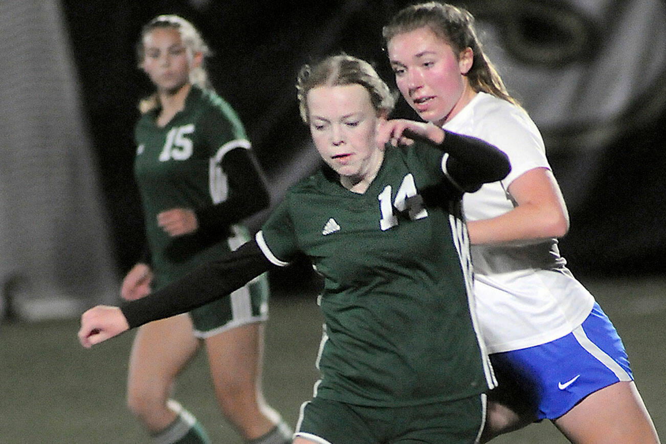 KEITH THORPE/PENINSULA DAILY NEWS
Port Angeles' Anna Petty, front, weaves around the defense of Bremerton's Claire Warthen as Petty's teammate, Kennedy Rognlien looks on from behind on Wednesday at Wally Sigmar Field in Port Angeles.