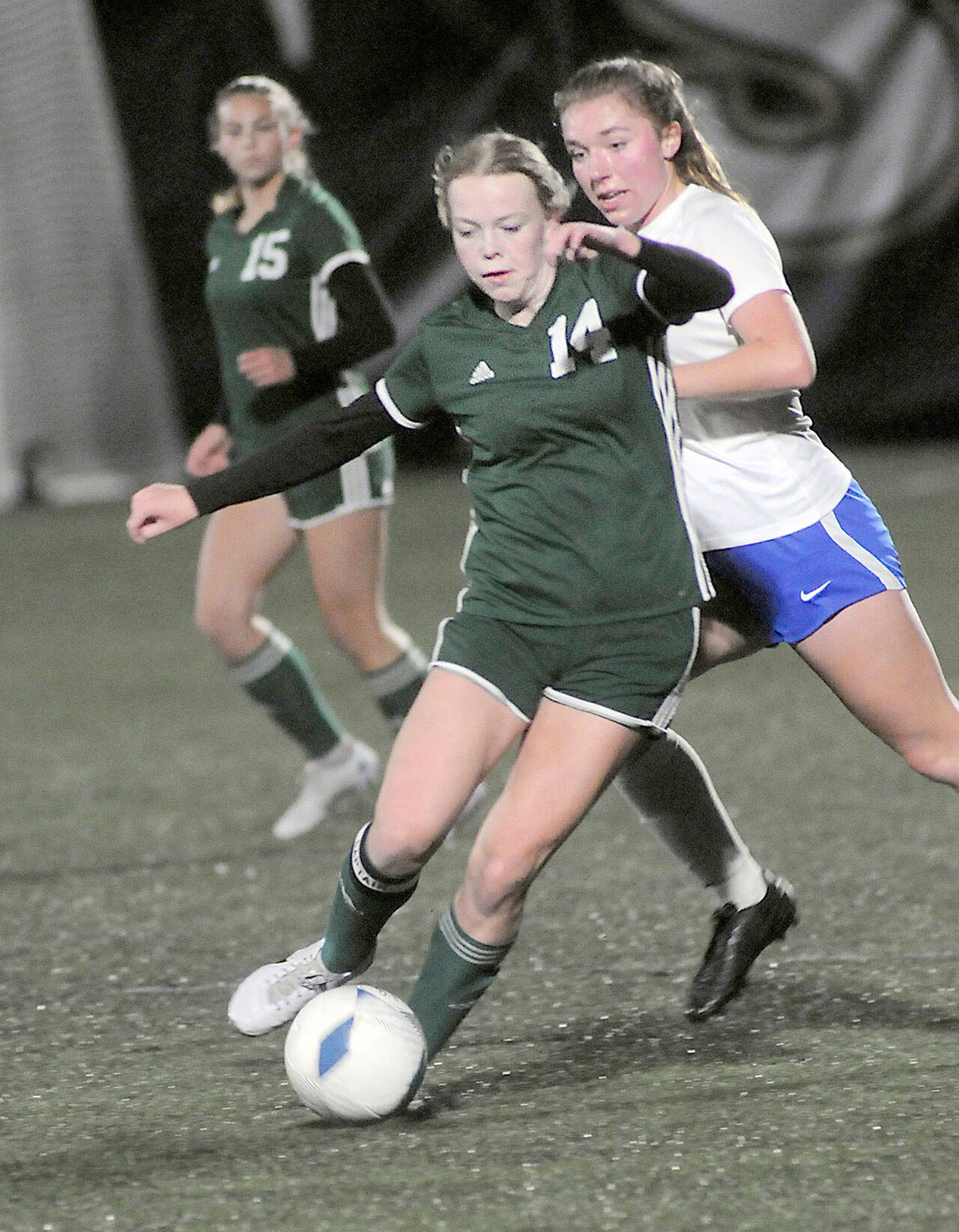 KEITH THORPE/PENINSULA DAILY NEWS Port Angeles Anna Petty, front, weaves around the defense of Bremertons Claire Warthen as Pettys teammate, Kennedy Rognlien looks on from behind on Wednesday at Wally Sigmar Field in Port Angeles.