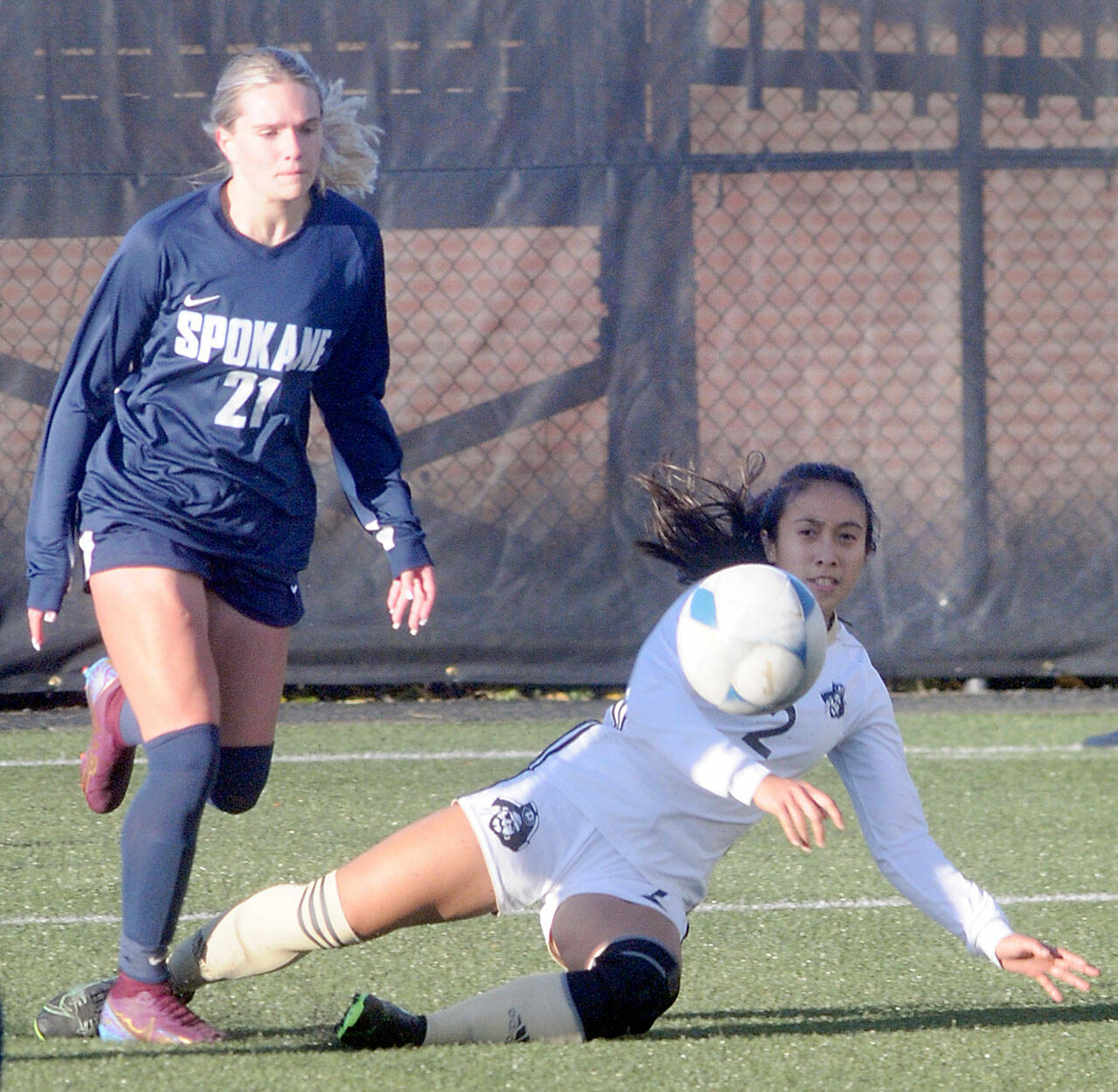 Peninsulas Briana-Jean Tanaka, right, makes a sliding tackle on Spokanes Peyton Bastine on Saturday in Port Angeles. (Keith Thorpe/Peninsula Daily News)