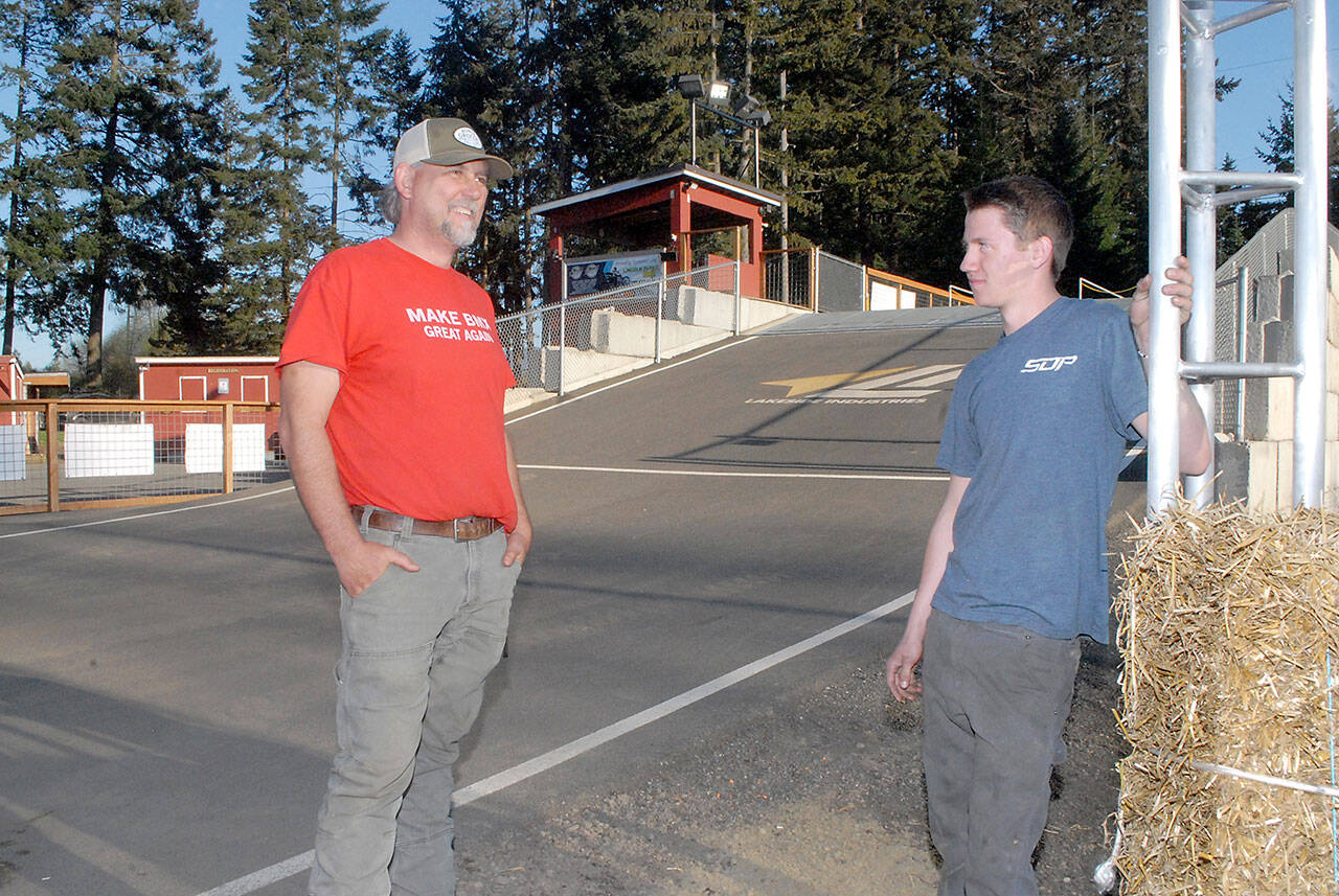 Keith Thorpe/Peninsula Daily News Lincoln Park BMX track operator Sean Coleman, left, talks with track design assistant Colby Groves earlier this year. Coleman was named volunteer of the year by the Washington Festivals and Events Association.