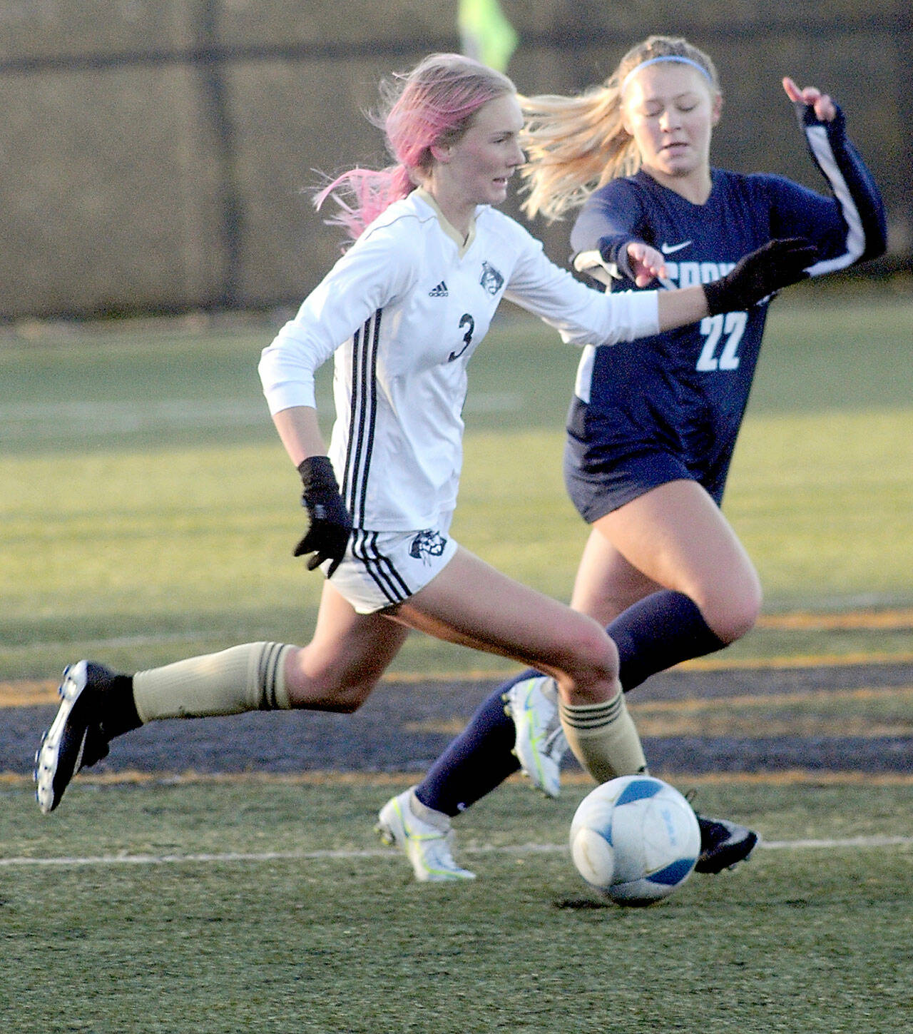 KEITH THORPE/PENINSULA DAILY NEWS Peninsulas Millie Long, left, races downfield with Spokanes Aubrey Thomas in pursuit during Saturdays NWAC quarterfinal game at Wally Sigmar Field in Port Angeles.