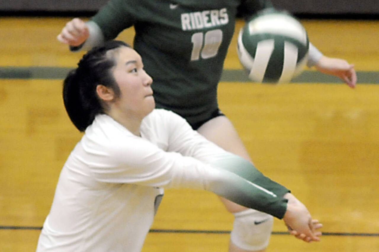 Port Angeles libero Cindy Liang, center, sets the ball in a match in September in Port Angeles. Liang had 94 digs in three matches at the district volleyball tournament. (Keith Thorpe/Peninsula Daily News)