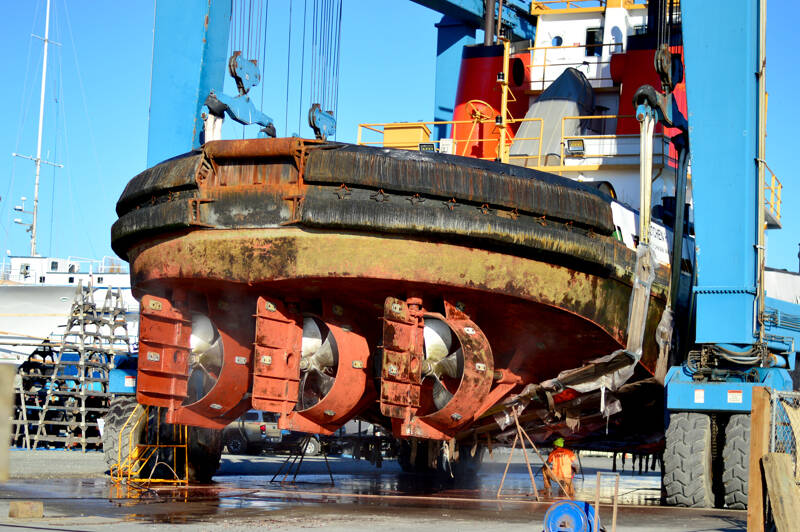The 65-ton Gretchen H tugboat got a bath at the Boat Haven in Port Townsend on Monday. After the marine travel-lift brought her out of the water, maintenance workers including Chad Tichgelaar pressure washed the 81-foot vessel under a bright sun. “It was a heckuva haul-out,” Tichgelaar said. (Diane Urbani de la Paz/For Peninsula Daily News)