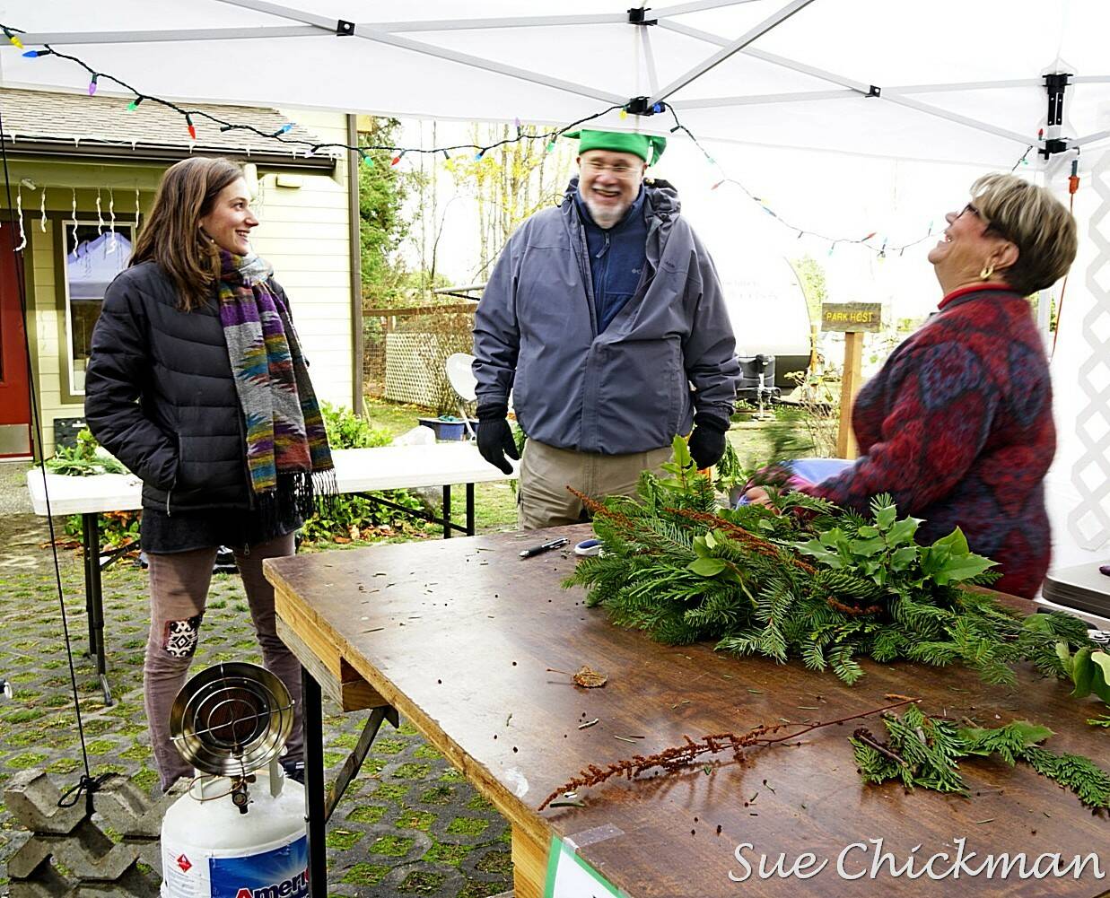 Tuttie Peetz, right, brings her wreath-making equipment and piles of greens, cones and ribbons to the River Center Holiday Nature Mart this weekend. The sale of handcrafted items, holiday wreaths and arrangements, baked goods and candy, is set for Saturday and Sunday to support the Dungeness River Nature Center’s education programs. (Submitted photo)