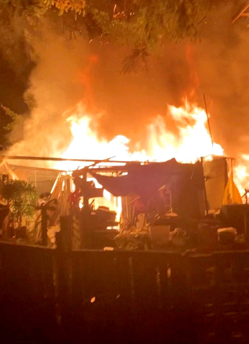 A detached shop burns near a house on Lillian Street in Port Hadlock.