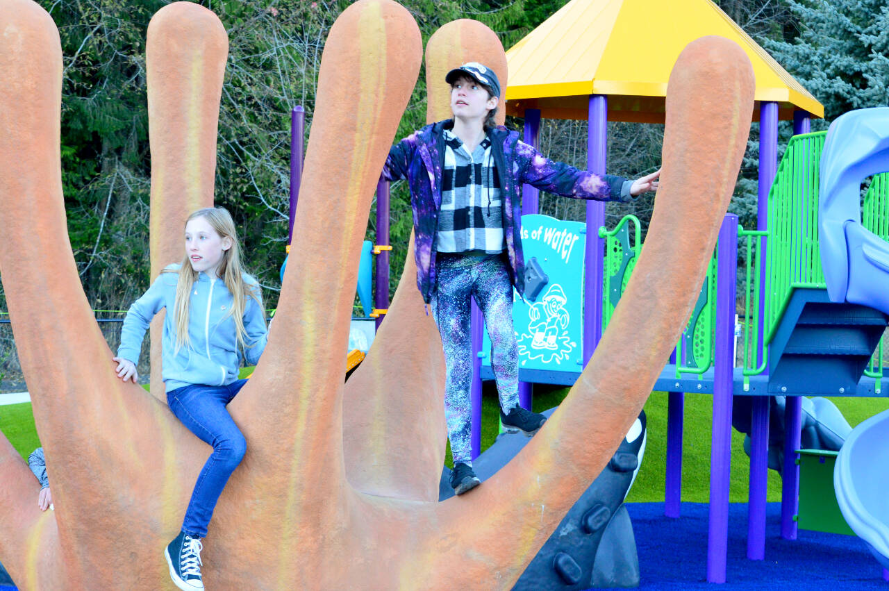 Darby Berg and Karl Sachs, both 12, are among the first to climb onto artist Rebecca Welti’s sea creature sculpture at the JUMP— Jefferson Universal Movement Playground — in Chimacum.