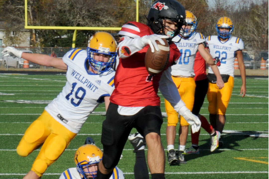 Lonnie Archibald/for Peninsula Daily News
Neah Bay's Jodell Wimberley scores one of his five touchdowns against Wellpinit in the state 1B quarterfinals held in Forks, just getting past Wellpinit's Andrew Moyer (19). Neah Bay won 66-14.