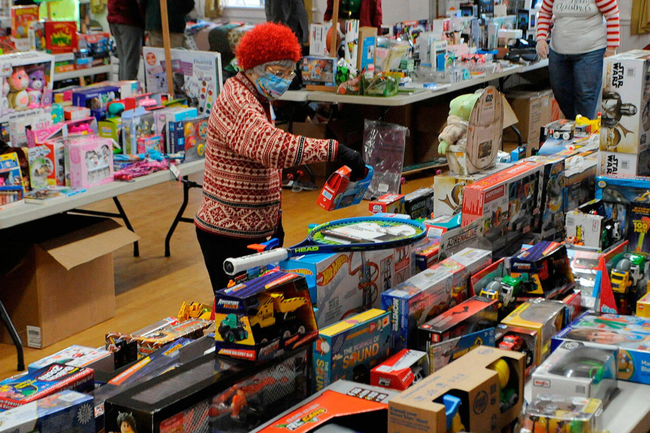 Volunteer Pat Gritman sorts toys at last year’s Toys for Sequim Kids event. The annual event returns Dec. 14 to the Sequim Prairie Grange with donations accepted throughout the area through Dec. 12. (Matthew Nash /Olympic Peninsula News Group)