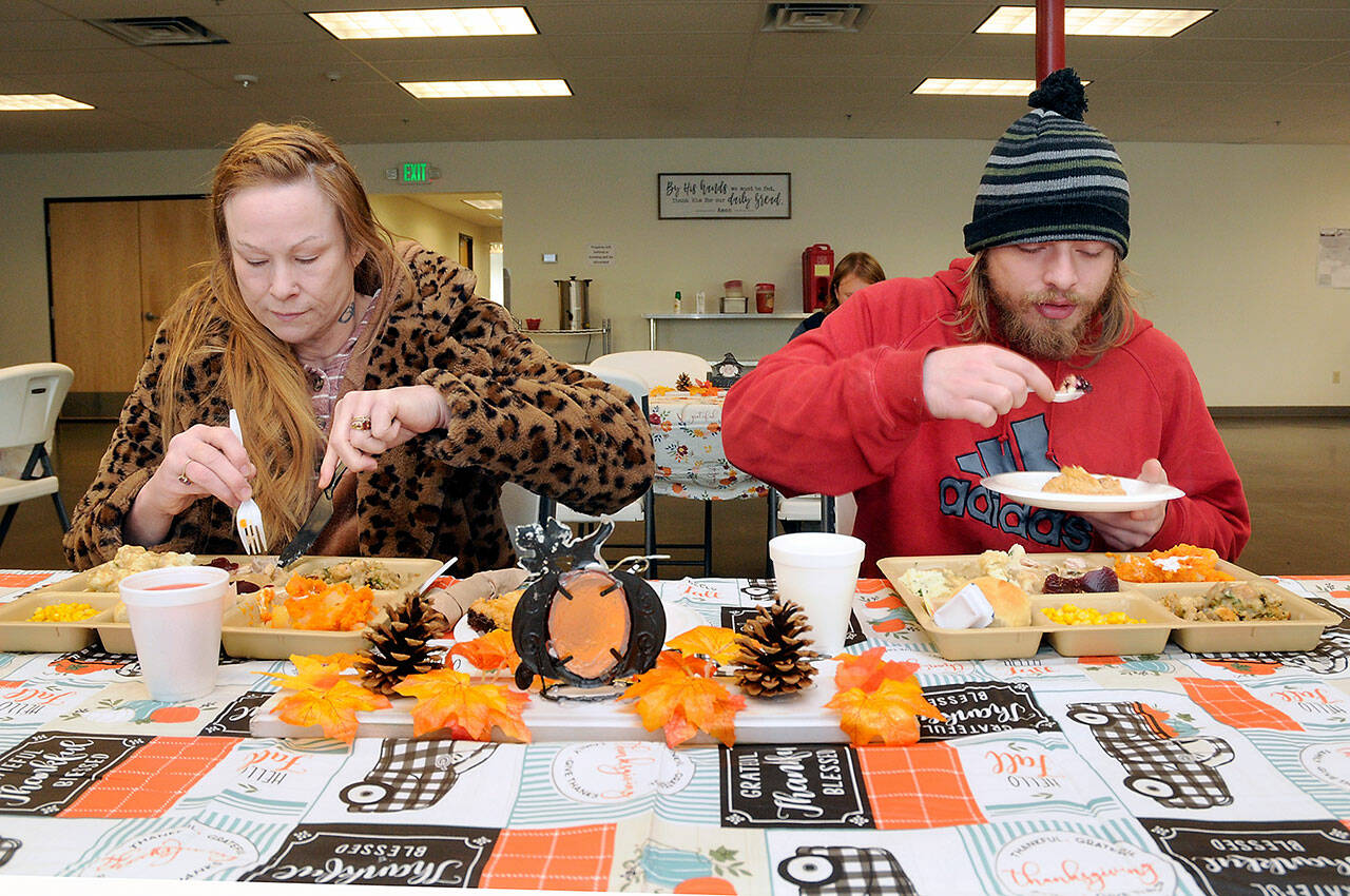 Sena Nucaro, left, and her son, Isaiah Breeden, both of Port Angeles, enjoy a traditional holiday meal during Wednesday’s Thanksgiving Eve lunch at the Port Angeles Salvation Army. (Keith Thorpe/Peninsula Daily News)