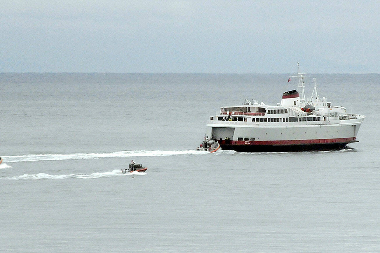 KEITH THORPE/PENINSULA DAILY NEWS
U.S. Coast Guard and law enforcement chase boats follow the ferry MV Coho during an armed passenger drill on Tuesday near the mouth of Port Angeles Harbor.
