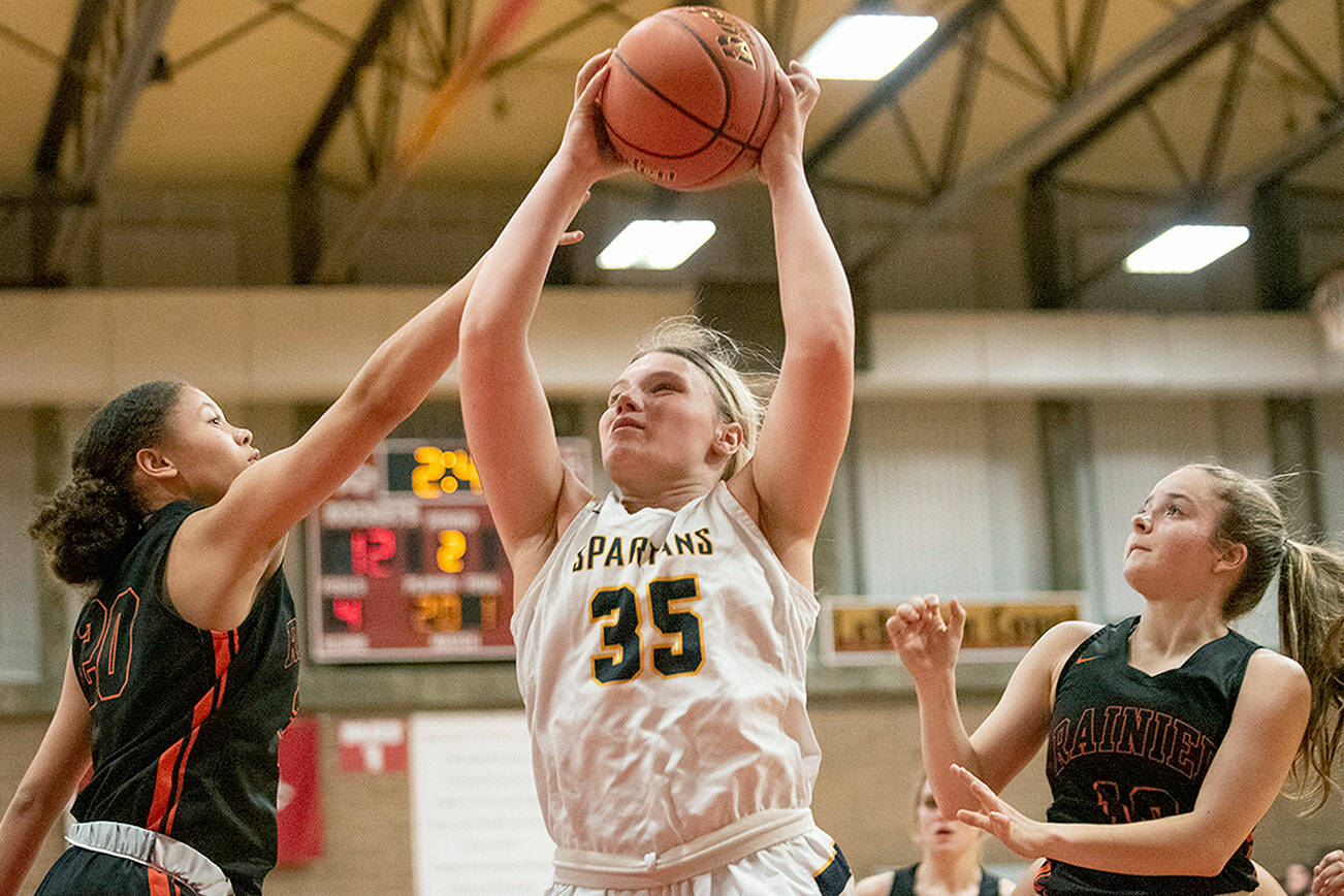 Eric Trent/The Chronicle 
Forks' Kyra Neel (35) hauls in a rebound in a Class 2B District IV playoff game against Rainier last February at Castle Rock High School. Neel returns as a four-year starter for the Forks varsity.