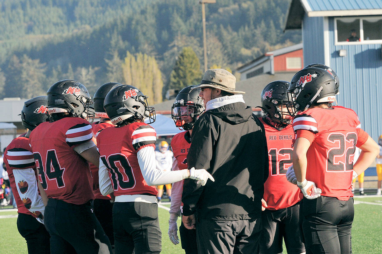 Neah Bay head coach Kane Bachelor instructs his players during the Red Devils’ 66-14 state quarterfinal win over Wellpinit. Neah Bay faces Liberty Bell for the 1B state championship at noon Saturday at Mount Tahoma High School. (Lonnie Archibald/for Peninsula Daily News)