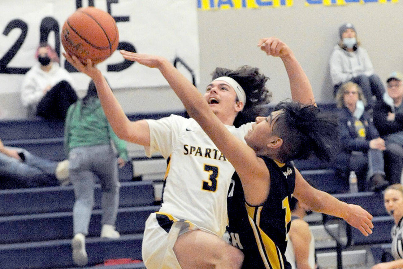 Lonnie Archibald/for Peninsula Daily News
Forks' Landin Davis attempts a layup during a game against North Beach last season. Davis is set to start for the Spartans this season.