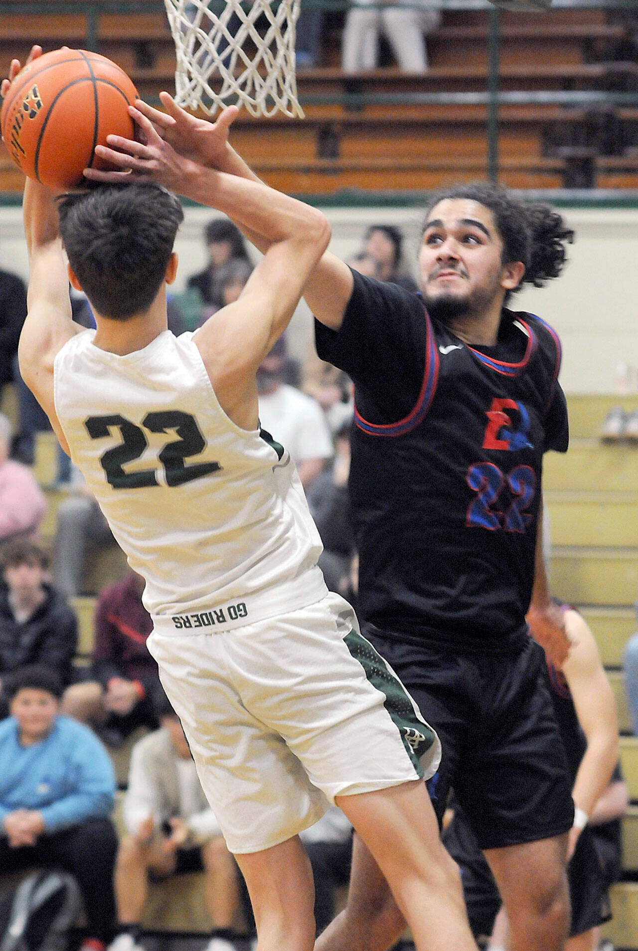KEITH THORPE/PENINSULA DAILY NEWS East Jefferson’s Lorenzo McCleese, right denies a shot by Port Angeles’ Tyler Hunter during Thursday’s game in Port Angeles.