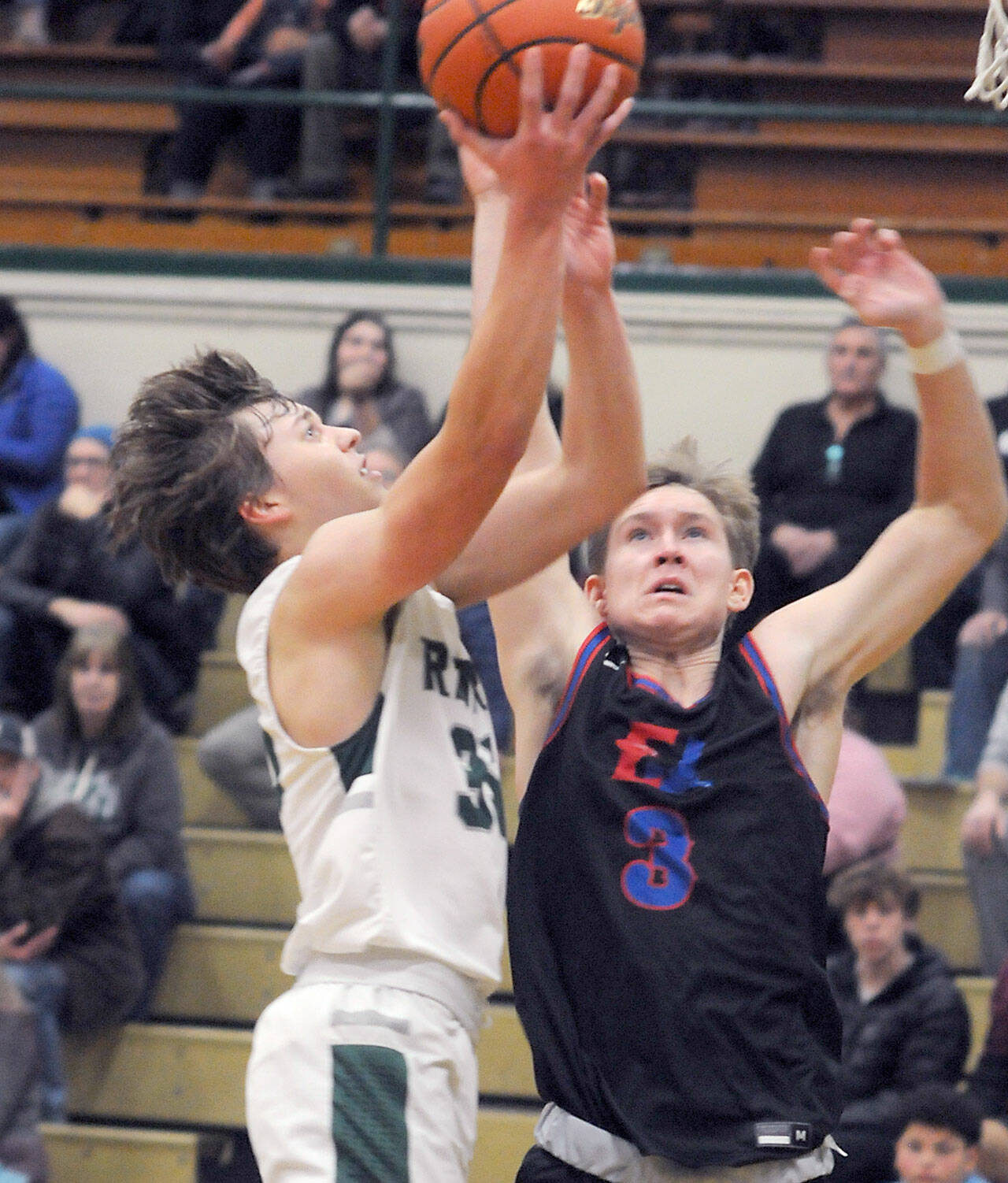 KEITH THORPE/PENINSULA DAILY NEWS Port Angeles’ Parker Nickerson, left, looks for the layup as East Jefferson’s Cash Holmes defends the lane on Thursday at Port Angeles High School.