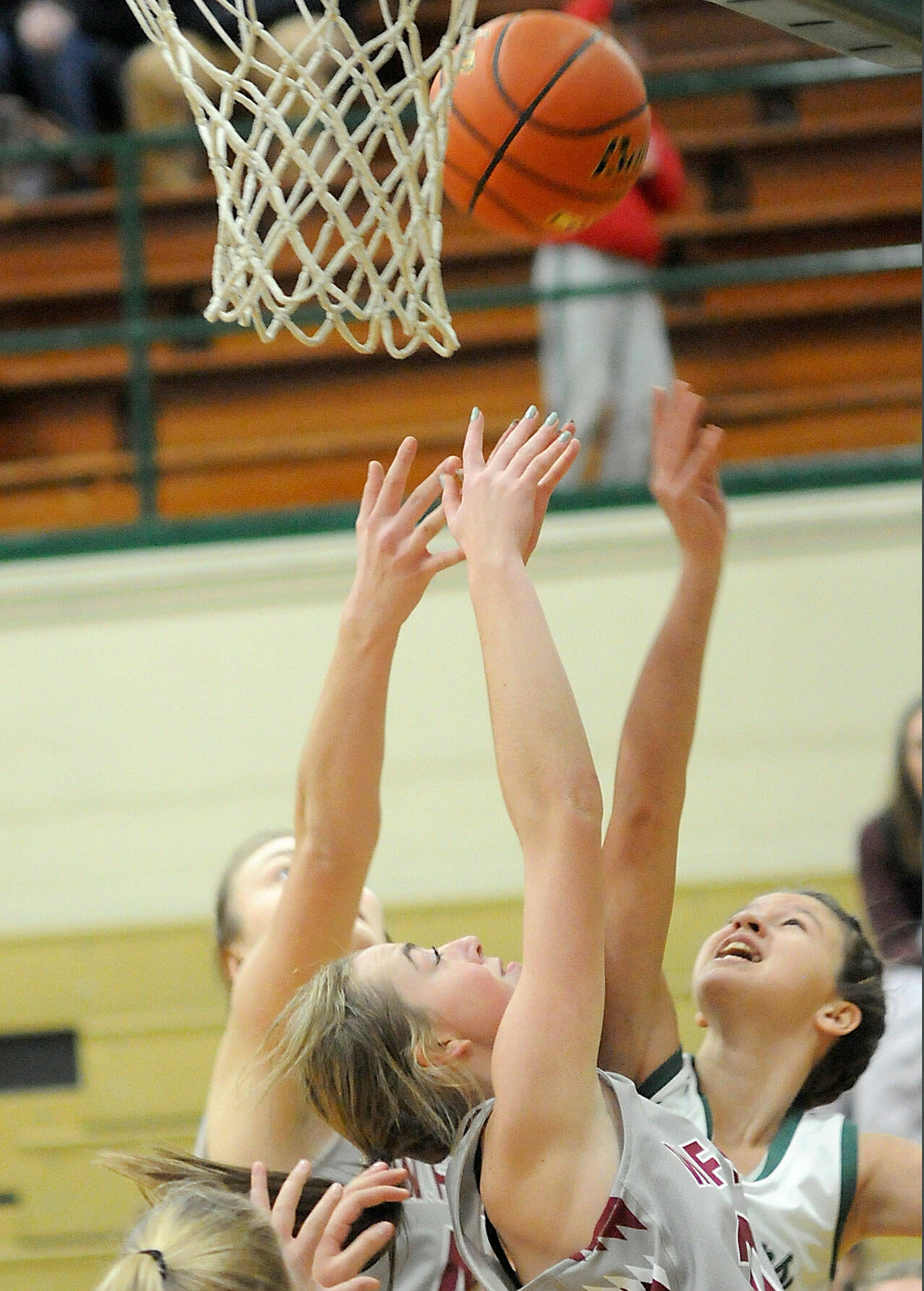 Port Angeles’ Lindsay Smith, right, puts up the ball as W.F West’s Julia Dalan, left, and Morgan Rogerson, front, scramble for the rebound on Saturday at Port Angeles High School. (Keith Thorpe/Peninsula Daily News)