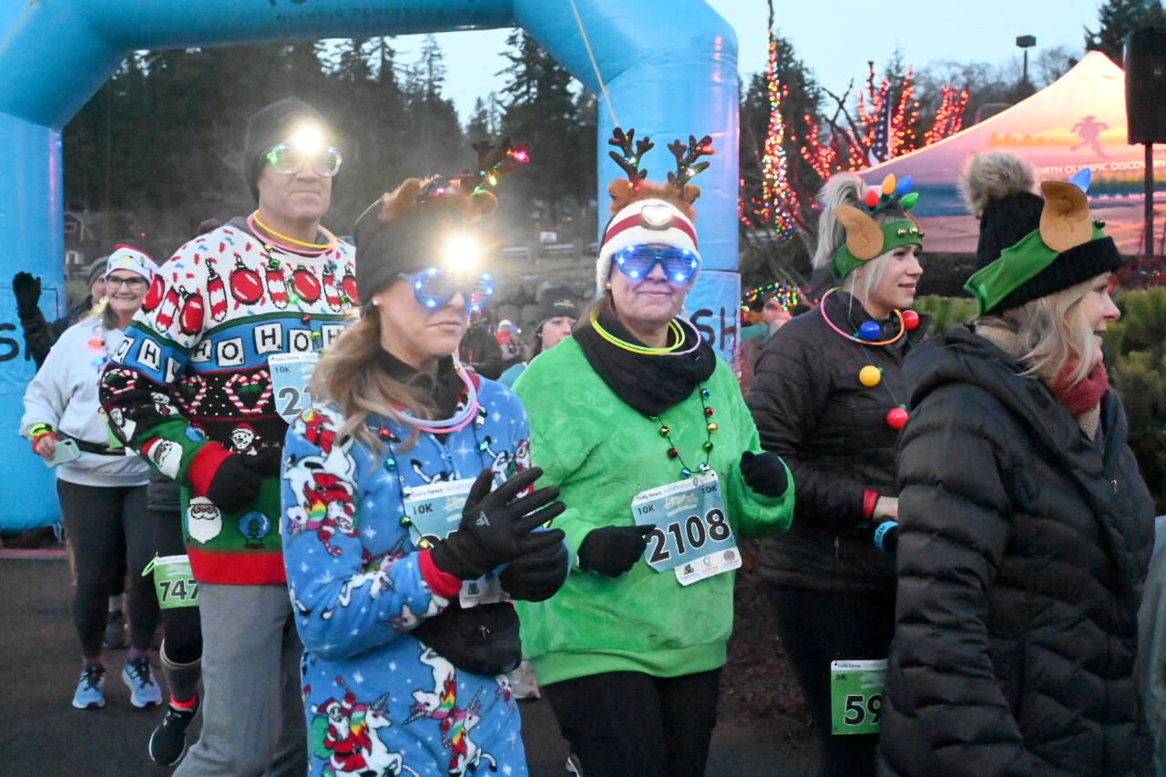 Jennifer Zbaraschuk of Sequim (2108) is among the competitors in the Jamestown S’Klallam Run who take off late Saturday afternoon in Blyn. Runners competed in 5K and 10K races, wearing headlamps in the twilight and dark. (Michael Dashiell/Olympic Peninsula News Group)