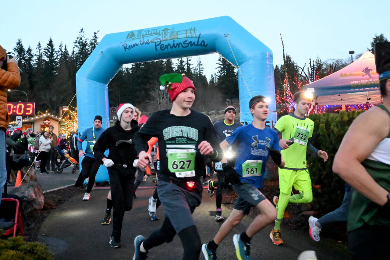 Noah Plotnik of Sequim (627), Dylan Zehr of Maple Valley (561) and Sean Southard of Sequim (722) take off in the Jamestown S’Klallam Run late Saturday afternoon in Blyn. Runners competed in 5K and 10K races, wearing headlamps in the twilight and dark. (Michael Dashiell/Olympic Peninsula News Group)