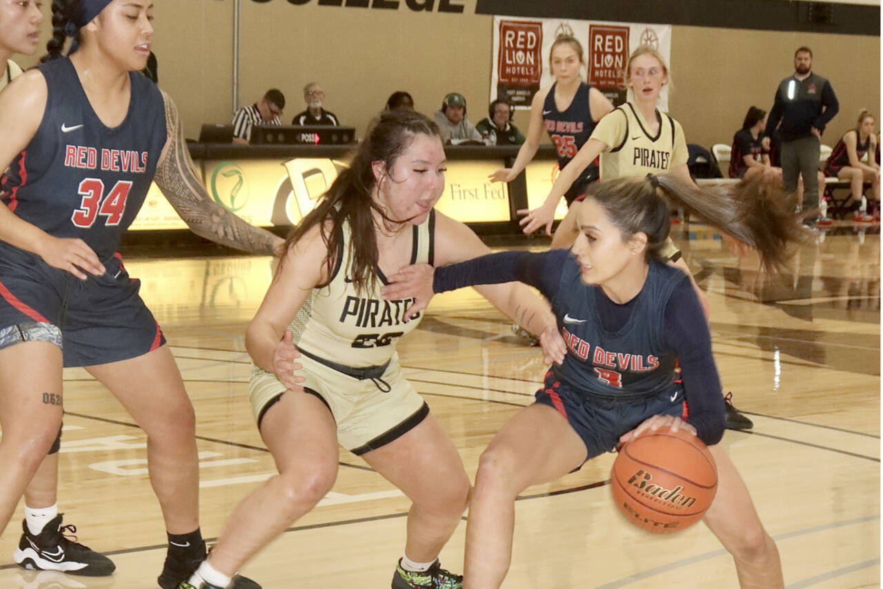 Lower Columbia's Courtney Swan, of Neah Bay, drives against her former Neah Bay teammate Ruth Moss, who now plays for Peninsula College. In on the play are Lower Columbia's Aivine Soakai (34), Kyla McCallum (25) and Peninsula's Millie Long, far right, background.
(Dave Logan/for Peninsula Daily News)