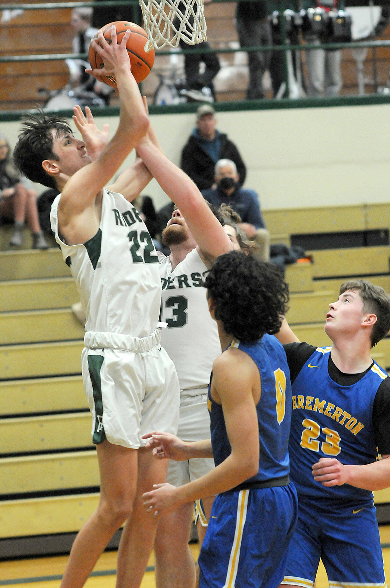 Port Angeles’ Tyler Hunter, left, grabs a rebound as teammate Ezra Townsend backs him up while Bremerton’s Trevon Pietz, front, and Oliver Christian, left, look for an opportunity on Tuesday night in Port Angeles. (Keith Thorpe/Peninsula Daily News)