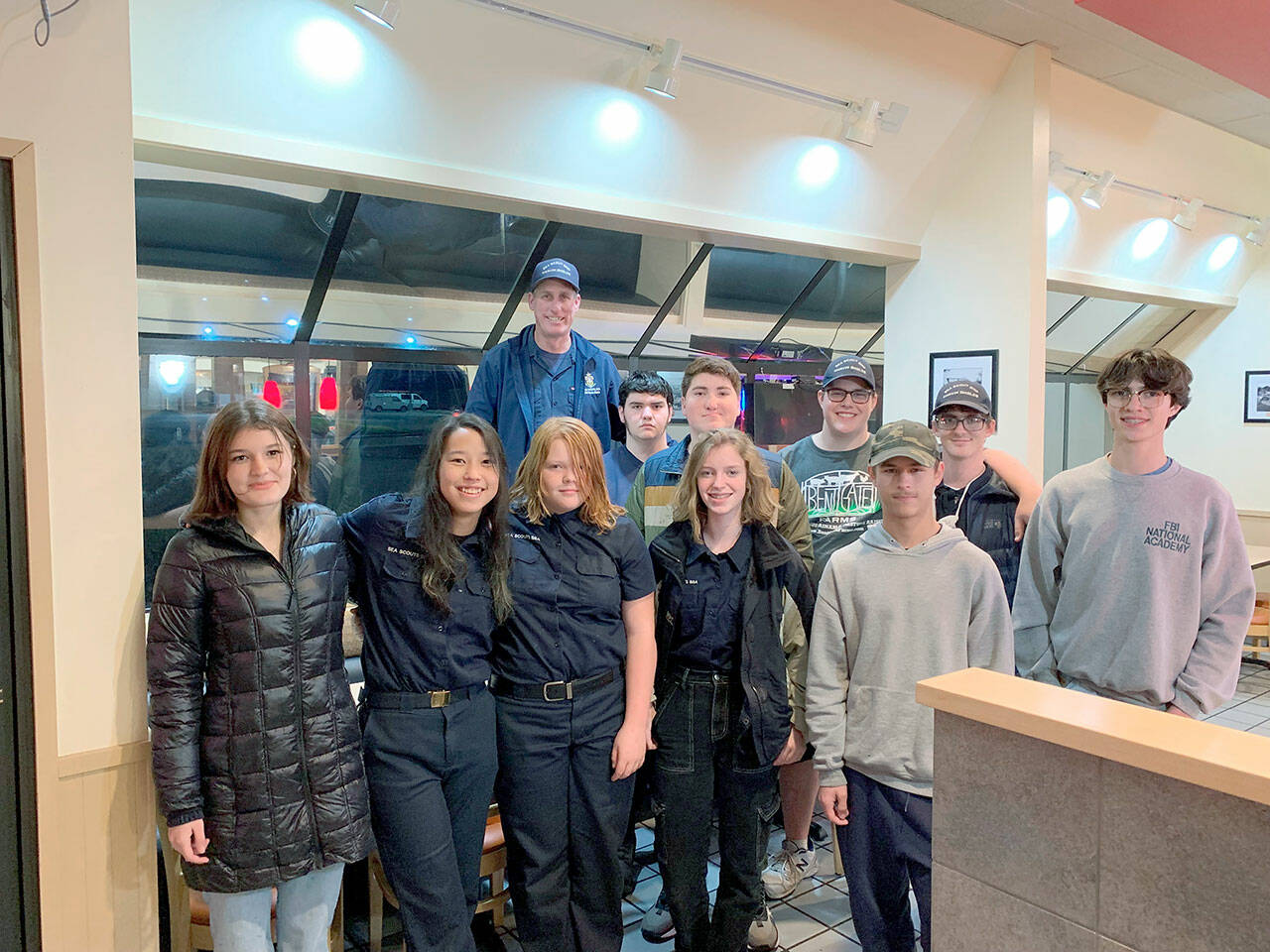 Pictured in the front row, from left to right are Bella Sains, Ana Gustafson, Leyla Price, Brenna Murphy, Michael Aranda and Andrew Corson. Back row, left to right are Sea Scout leader Jared Minard, Elliot Dahlin, Rynn Hays, Adian Carlquist-Bundy and Michael Rodgers. Not pictured are Dean Spaulding, Ella Schulz, Ozzy Minard and Jonathan Bridges.