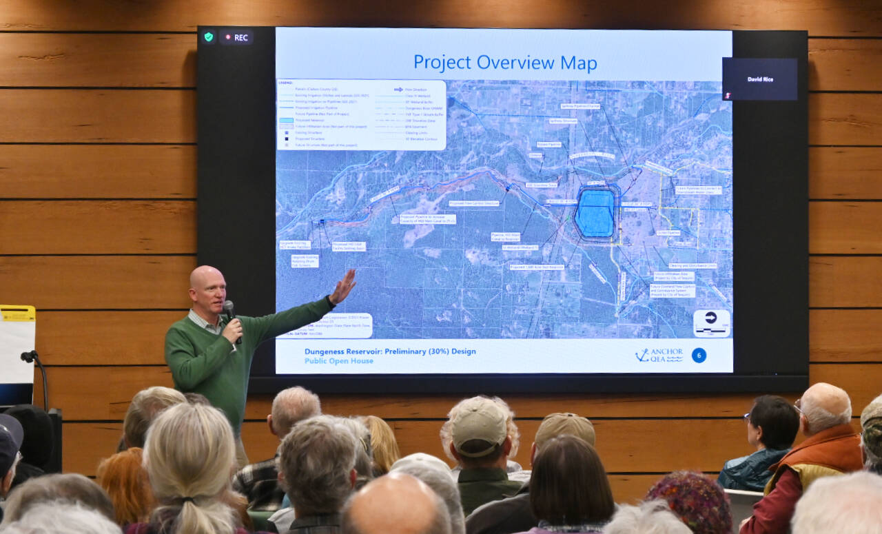Dave Rice, a principal water resources engineer with Anchor QEA — the lead engineering company for the Dungeness Off-Channel Reservoir project — gives an overview of the project to the audience at an open house at the Dungeness River Nature Center on Dec. 6. (Michael Dashiell/Olympic Peninsula News Group)