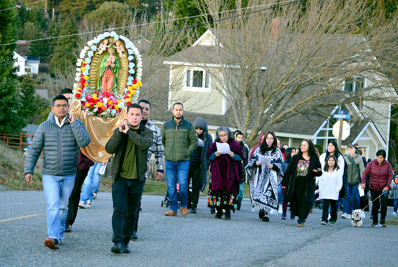 In honor of the Feast of Our Lady of Guadalupe, about 75 people paraded up Harrison Street in Port Townsend toward St. Mary Star of the Sea Catholic Church on Monday afternoon. The police-escorted procession marked the day on which Roman Catholics believe the Virgin Mary appeared to Juan Diego, an indigenous man, in 1531. Mary, known as Our Lady of Guadalupe in Mexico, is the patron saint of that country and “the Mother of us all,” according to a handout at the parish. St. Mary Star of the Sea, the only Catholic church in Jefferson County, celebrates Sunday masses in Spanish and in English. (Diane Urbani de la Paz/for Peninsula Daily News)