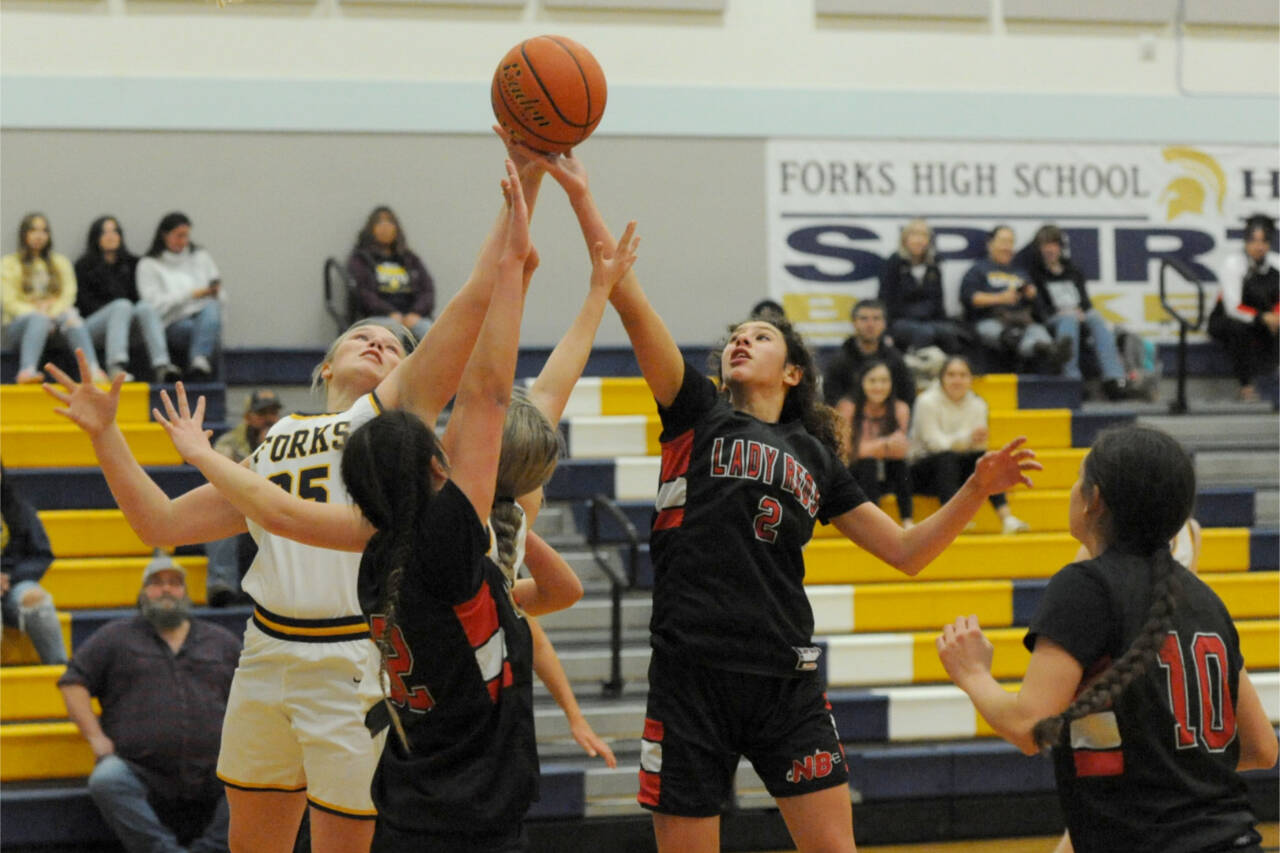 From left, Forks' Kyra Neel  competes with Neah Bay's Ryana Moss, Angel Halttunen and Allie Greene in Forks. Neah Bay came from behind in the closing minutes to defeat Forks 54-50 in a nonleague contest. Lonnie Archibald/for Peninsula Daily News