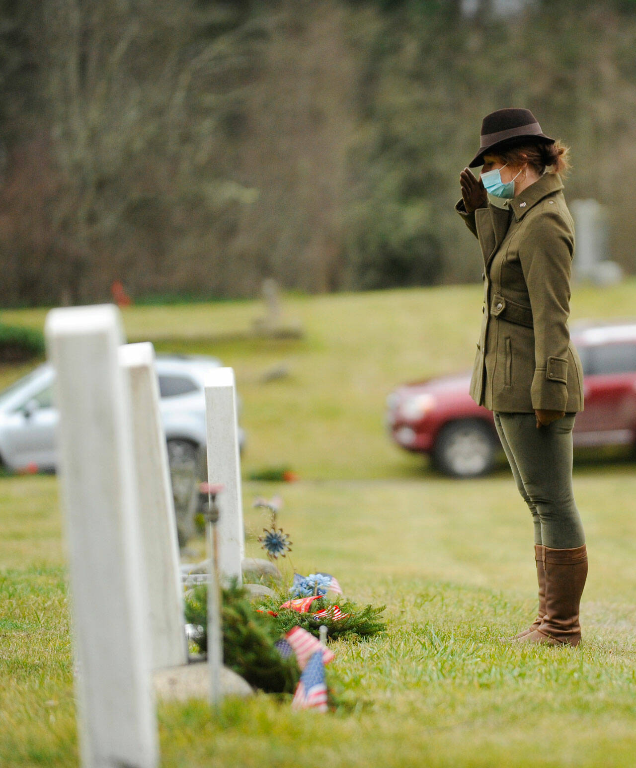 Lance Cpl. Holly Rowan, a U.S. Marine Corps veteran, salutes after laying a ceremonial wreath at the Wreaths Across America event at Sequim View Cemetery in 2020. (Michael Dashiell/Olympic Peninsula News Group)