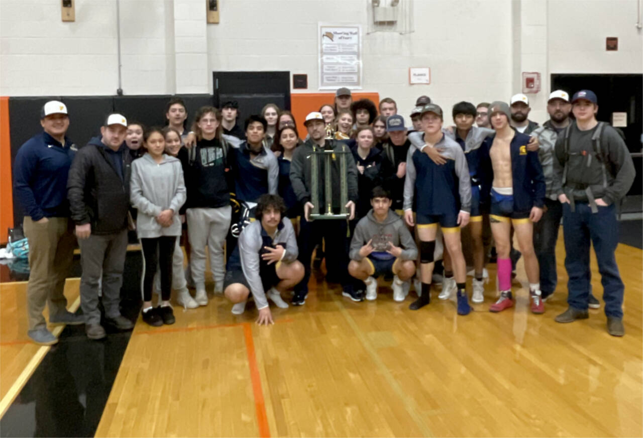 The Forks boys wrestling team celebrates its first-place trophy at the Rainier Duals Tournament this weekend. (Forks wrestling)