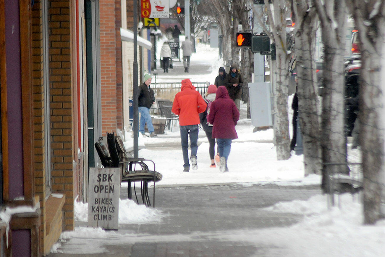 Pedestrians make their way along an icy stretch of First Street in downtown Port Angeles on a sub-freezing Thursday afternoon. (Keith Thorpe/Peninsula Daily News)