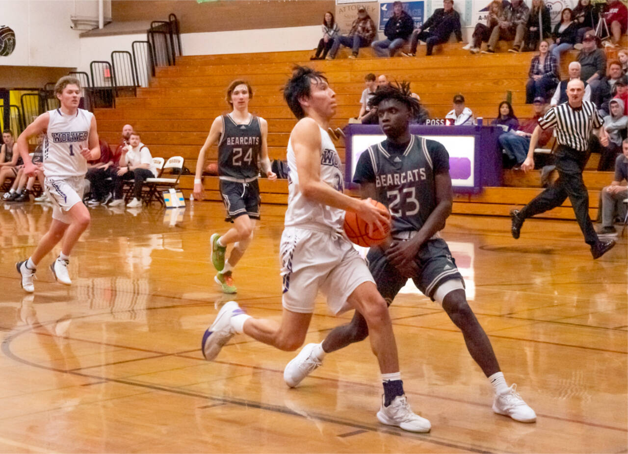 Emily Matthiessen/Olympic Peninsula News Group
Sequim's Isaiah Moore drives to the basket around the defense of WF West's Brian Anouma (23). Also in the play are Sequim's Zach Thompson (1) and WF West's Tyler Klatush (24).