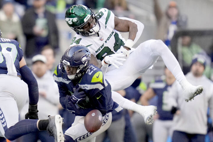 Seattle Seahawks safety Johnathan Abram (23) breaks up a pass intended for New York Jets wide receiver Corey Davis (84) during the second half of an NFL football game, Sunday, Jan. 1, 2023, in Seattle. (AP Photo/Godofredo A. Vásquez)