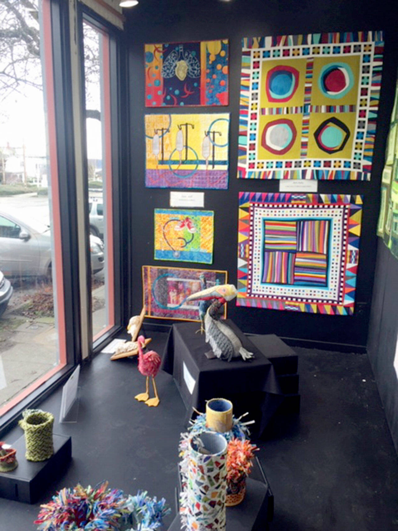 Among the pieces shown are, from left on the wall, quilts by Terri Wolf and Jeri Auty, both from Port Ludlow, and below, sculptures by Pat Herkal, with (foreground) ply-split vessels by Cathie Wier and 3-D constructions by Deb Olson, both from Port Townsend.