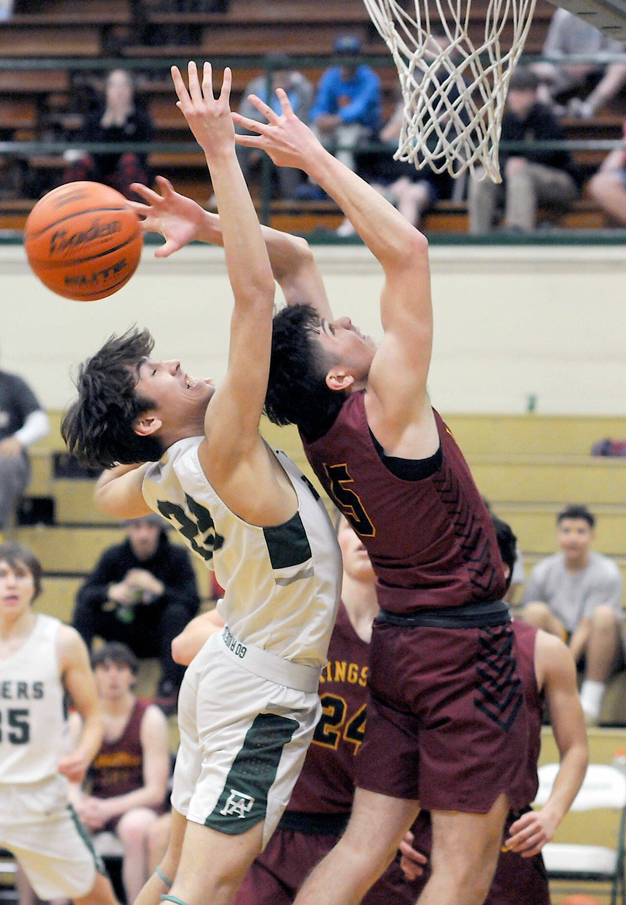 KEITH THORPE/PENINSULA DAILY NEWS Port Angeles’ Tyler Hunter, left, and Kingston’s Dakota Standley fight for a rebound during Thursday night’s game at Port Angeles High School.