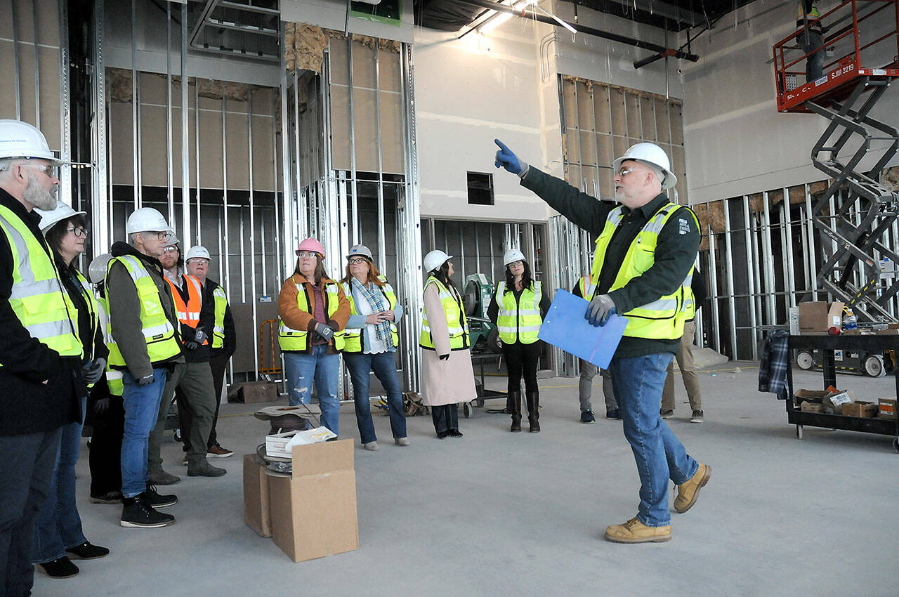 Chris Fidler, project director of the Field Arts and Events Hall, points out features of the under-construction building during a tour with members of the Clallam County Economic Development Council on Friday.(KEITH THORPE/PENINSULA DAILY NEWS)