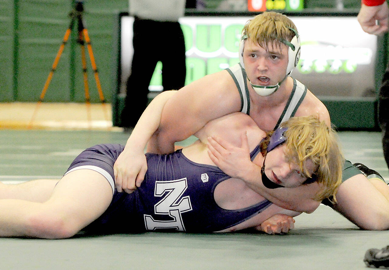 Thomas Arand of Port Angeles grapples with North Thurston’s Sean Bures in the 195-pound class on Saturday at Port Angeles High School. (Keith Thorpe/Peninsula Daily News)