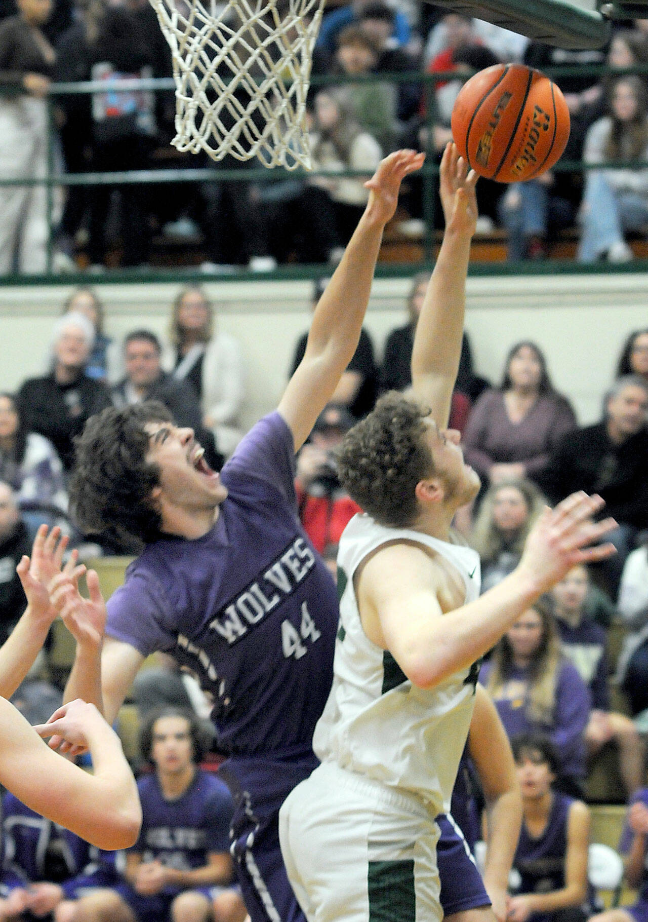 Sequims Cole Smithson, left, battles at the boards with Port Angeles Isaiah Shamp during Tuesdays conference game at Port Angeles High School. (Keith Thorpe/Peninsula Daily News)