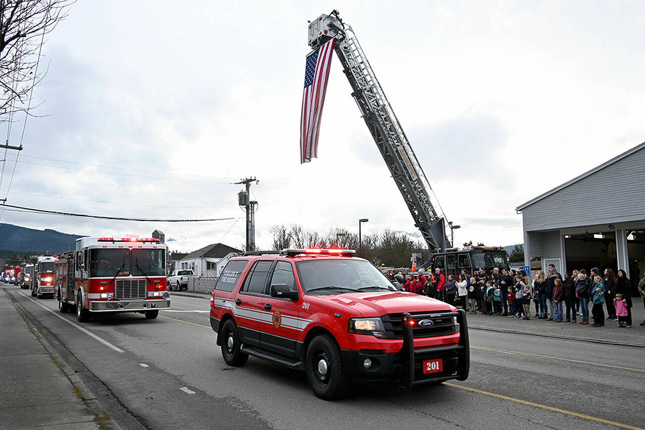Michael Dashiell/Olympic Peninsula News Group
Staffers from Clallam County Fire District 3 in Sequim, other North Olympic Peninsula fire departments and first responders honor Fire District 3 Capt. Charles "Chad" Cate with a procession of vehicles through Sequim on  Friday. Here, the procession passes by District 3's station on North Fifth Avenue. Firefighters escorted the body of Cate, who died in the early morning hours of Jan. 12 while on duty,  to Thurston County where an autopsy was performed, and then back through Sequim before delivering him to Sequim Valley Funeral Home. Cate, a Sequim High graduate, began serving as a volunteer firefighter in 1994, was hired by the fire district in 1997 as firefighter/paramedic, and promoted to the rank of captain in 2020. He leaves behind his wife, a 2 year-old son and two adult children. A full fire service memorial is being planned for Jan. 21.
Leah Leach