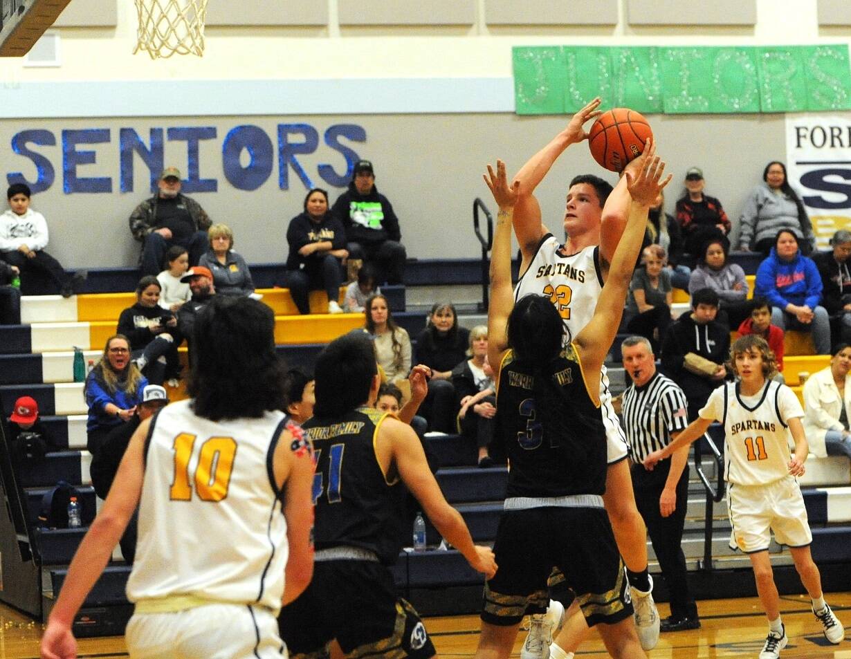 Brody Lausche (22), goes up for a jumper against Chief Leschi earlier this week. Lausche scored 11 points Friday night in a 58-21 victory over North Beach. Also in on the play are the Spartans' Dylan Micheau (10) and Kyle Lohrengel (11).
 (Lonnie Archibald/for Peninsula Daily News)