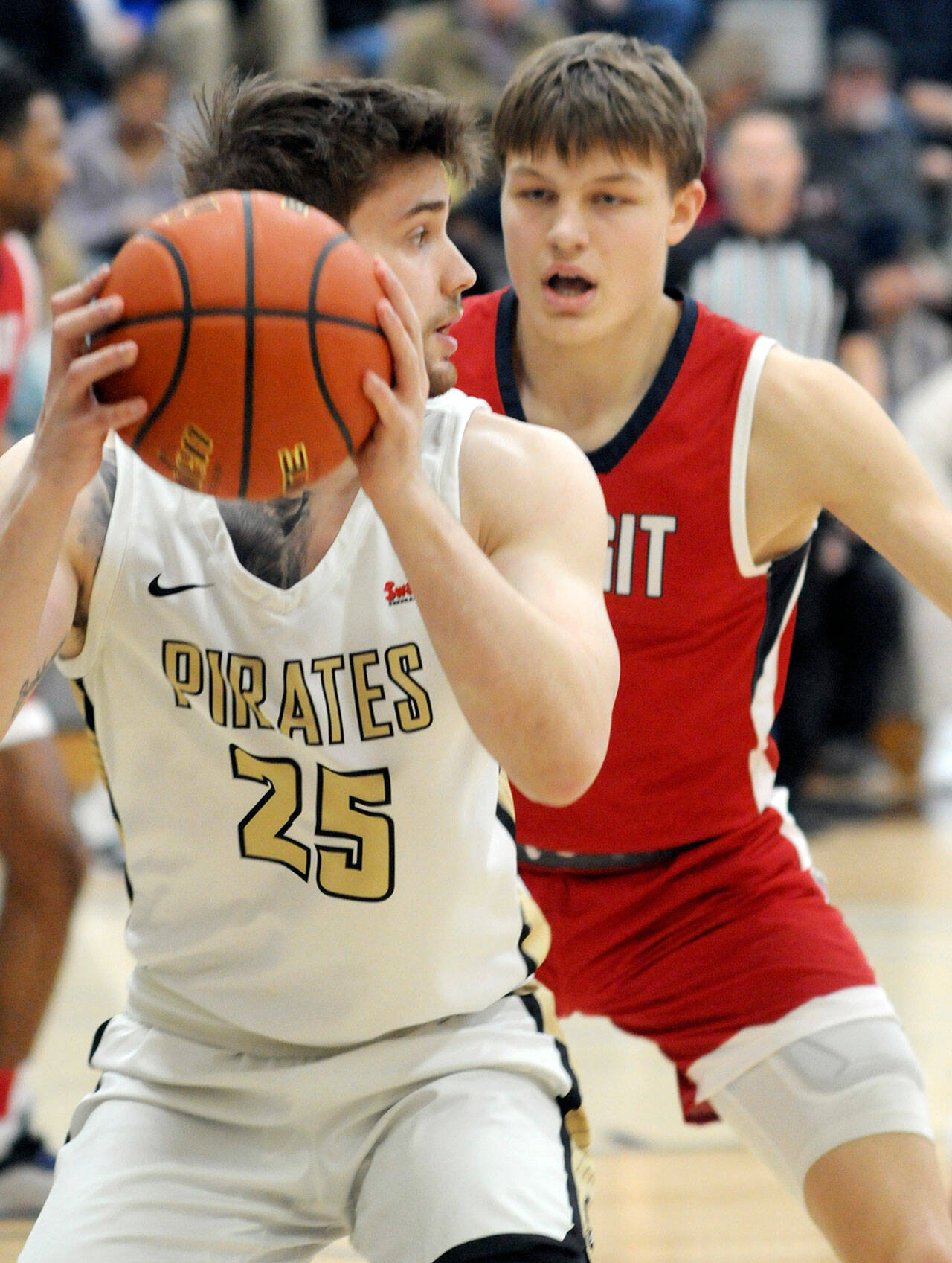 KEITH THORPE/PENINSULA DAILY NEWS
Peninsula's Max D'Amato, front, looks past the defense of Skagit Valley's Jacob Bilodeau on Wednesday night in Port Angeles.