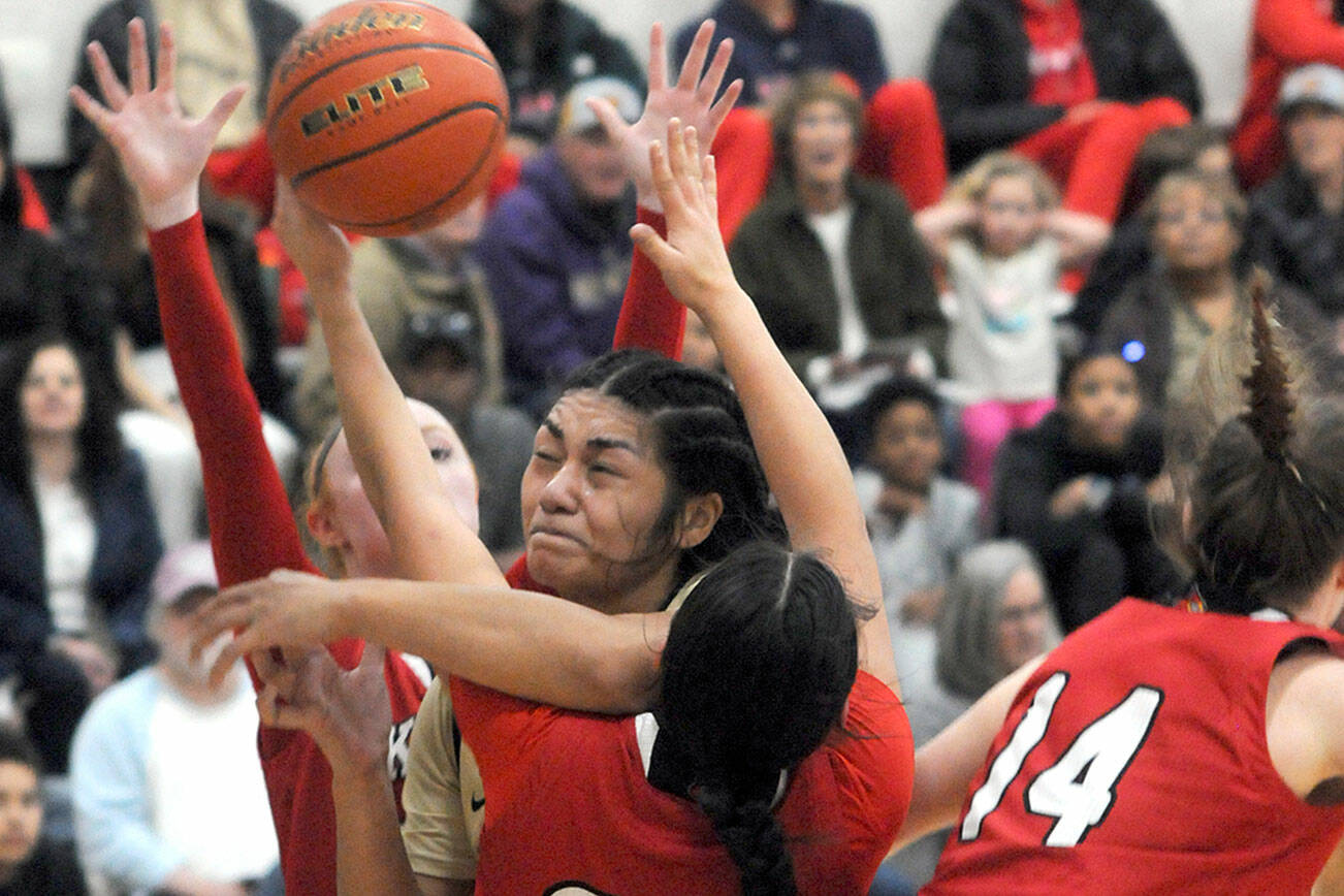 KEITH THORPE/PENINSULA DAILY NEWS
Peninsula's Ituau Tuisaula, center, bulls her way through the Skagit Valley defenders, from left, Kailyn Allison, Sarah Cook and Janae Rhoads on Wednesday night in Port Angeles.